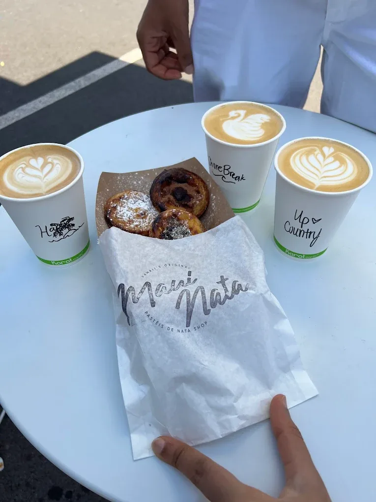 Three signature lattes labelled Hapa, Shore Break and Up Country beside Maui pastéis de nata.